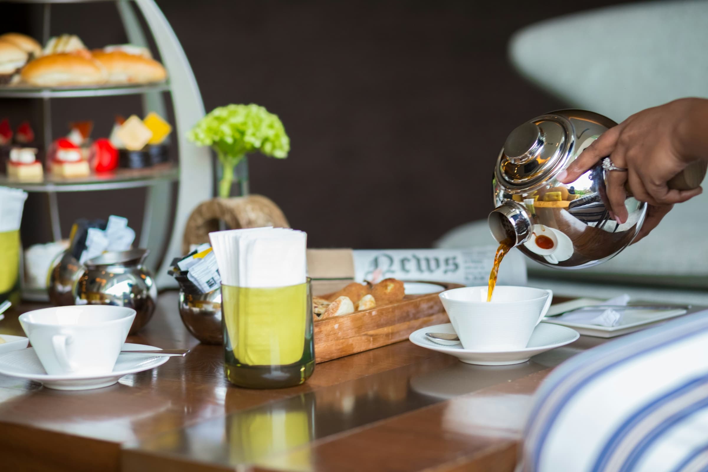 Ceylon tea being poured at a Colombo high-tea table