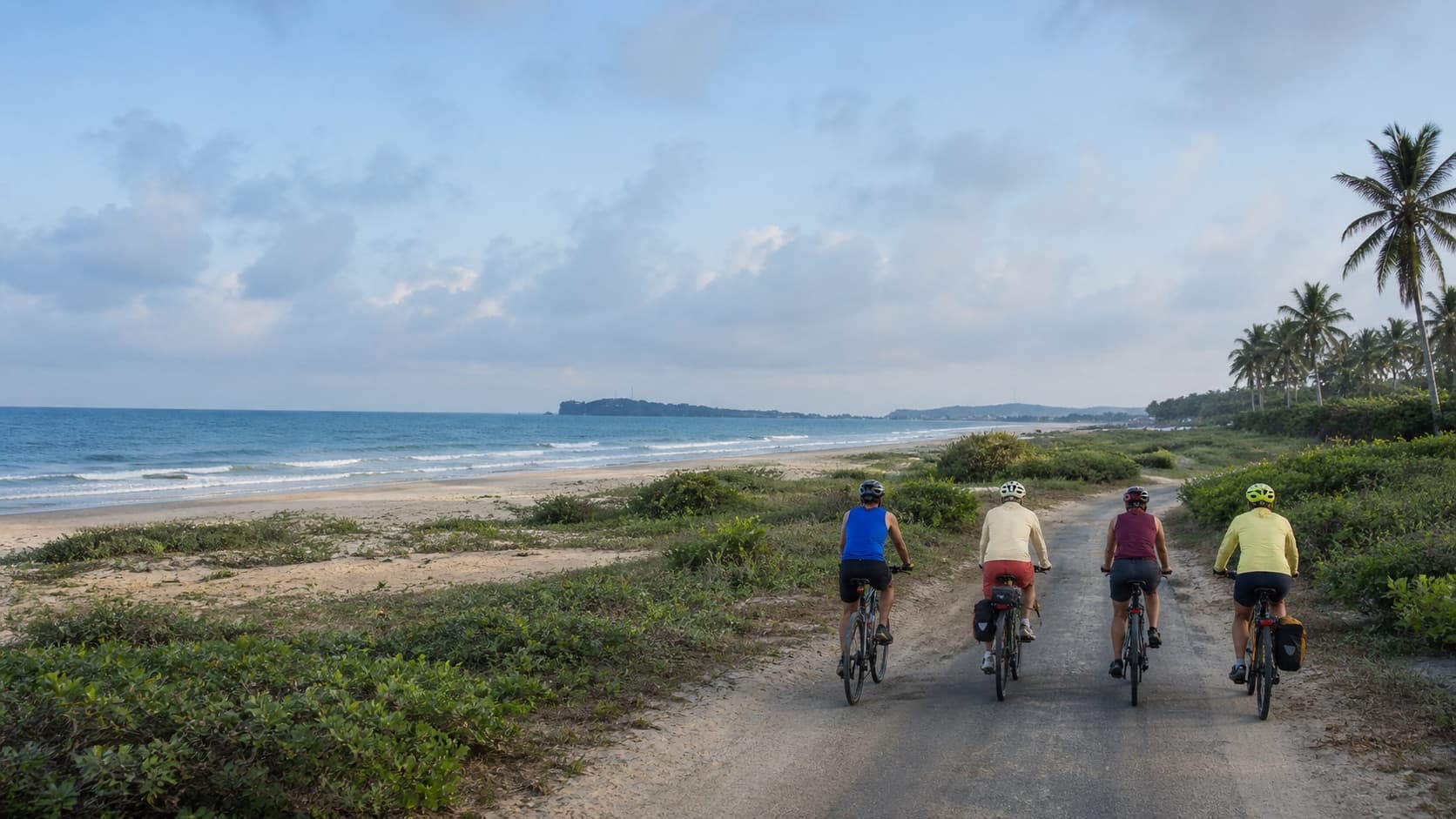 Cyclists riding the Nilaveli coast in Sri Lanka
