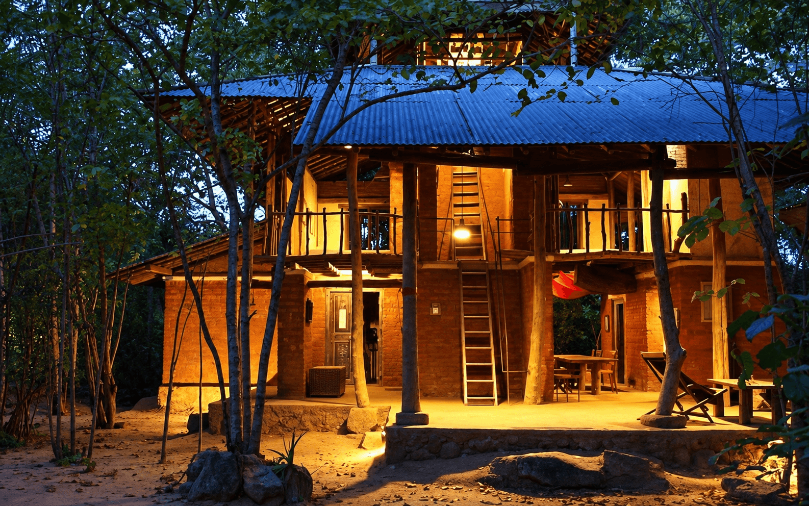 Galkadawala Forest Lodge glowing among trees at dusk