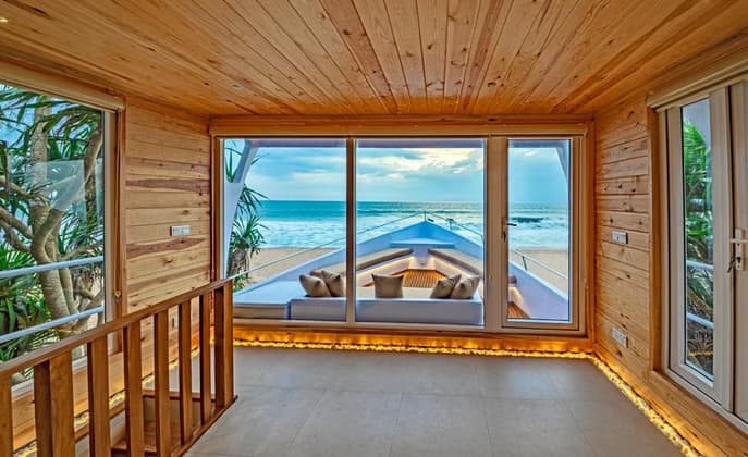 A timber room at Jungle Beach opening straight onto the ocean