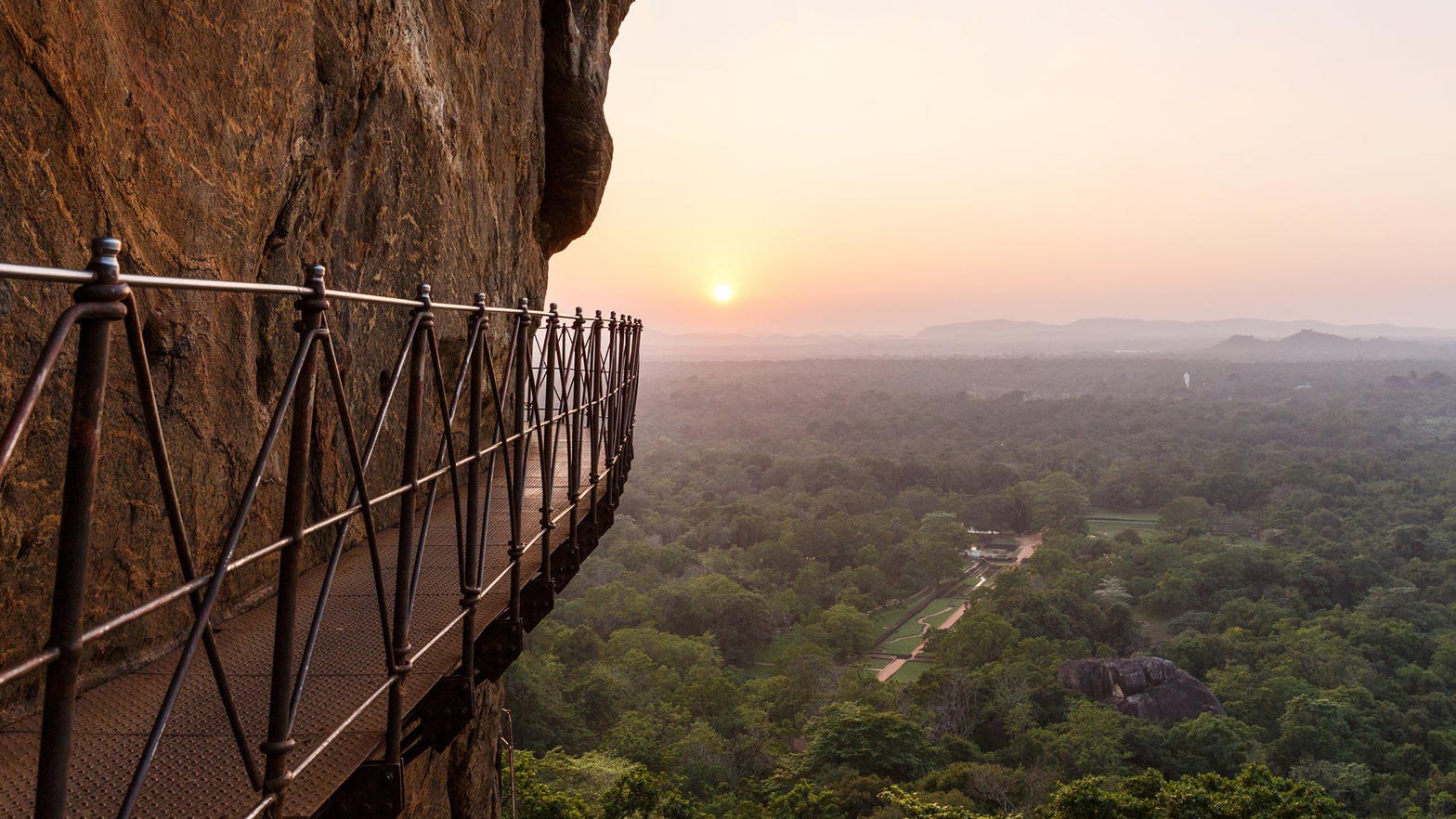 A cliffside walkway above the forest at sunset, Sigiriya